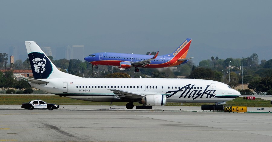 Southwest Airlines and Alaska Airlines planes are seen at the Los Angeles International Airport in this file photo. (Credit: Kevork Djansezian/Getty Images)