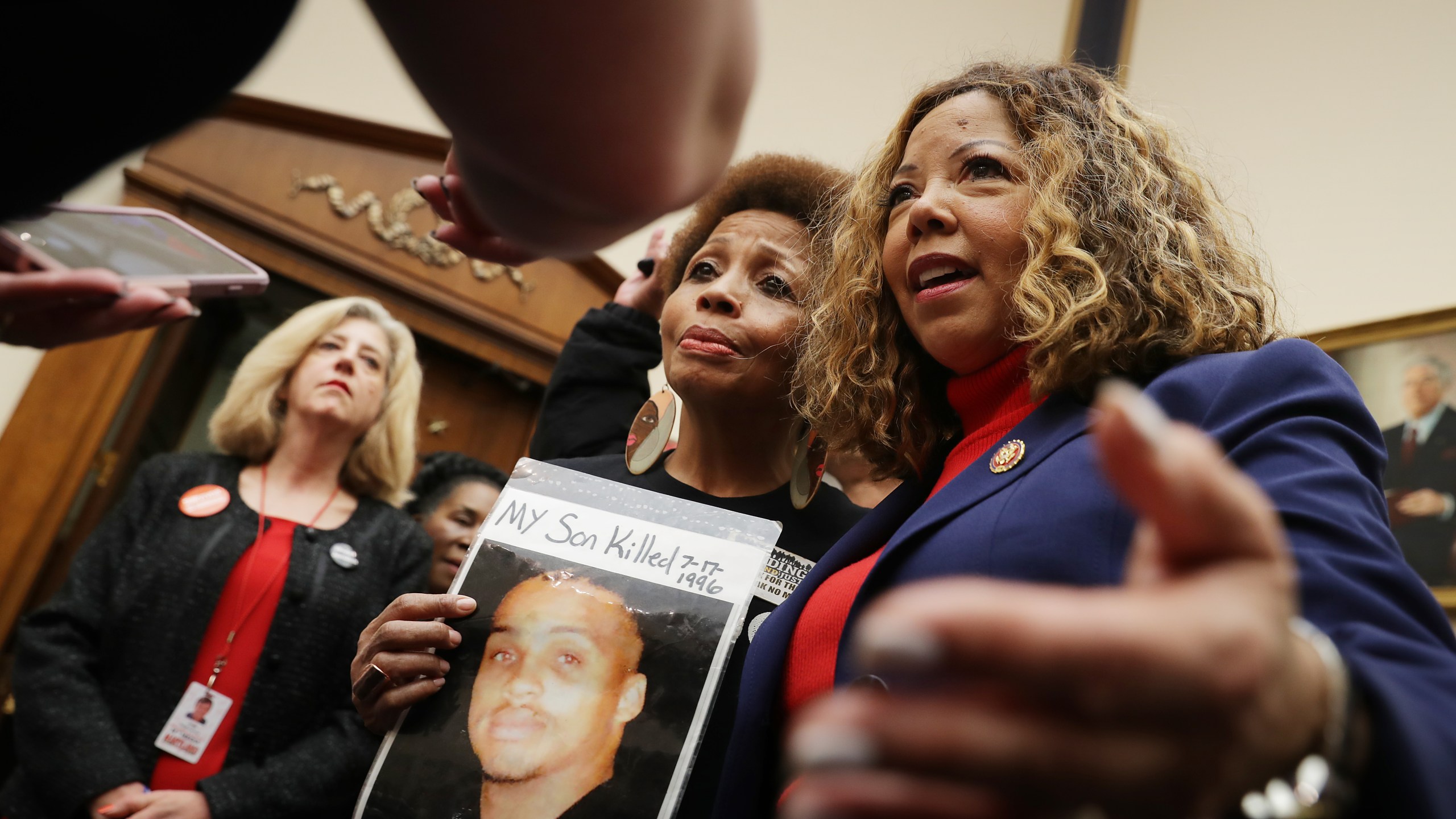 The Brady Campaign's Mattie Scott (C) and Rep. Lucy McBath (D-GA), both of who lost sons to gun violence, pose for photographs before a hearing on gun violence legislation in the Rayburn House Office Building on Capitol Hill February 06, 2019 in Washington, DC. (Credit: Chip Somodevilla/Getty Images)