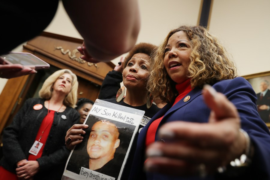 The Brady Campaign's Mattie Scott (C) and Rep. Lucy McBath (D-GA), both of who lost sons to gun violence, pose for photographs before a hearing on gun violence legislation in the Rayburn House Office Building on Capitol Hill February 06, 2019 in Washington, DC. (Credit: Chip Somodevilla/Getty Images)