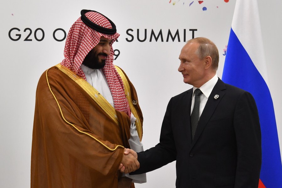 Russia's President Vladimir Putin, right, shakes hands with Saudi Arabia's Crown Prince Mohammed bin Salman during a meeting on the sidelines of the G20 Summit in Osaka, Japan, on June 29, 2019. (Credit: Yuri Kadobnov / AFP / Getty Images)