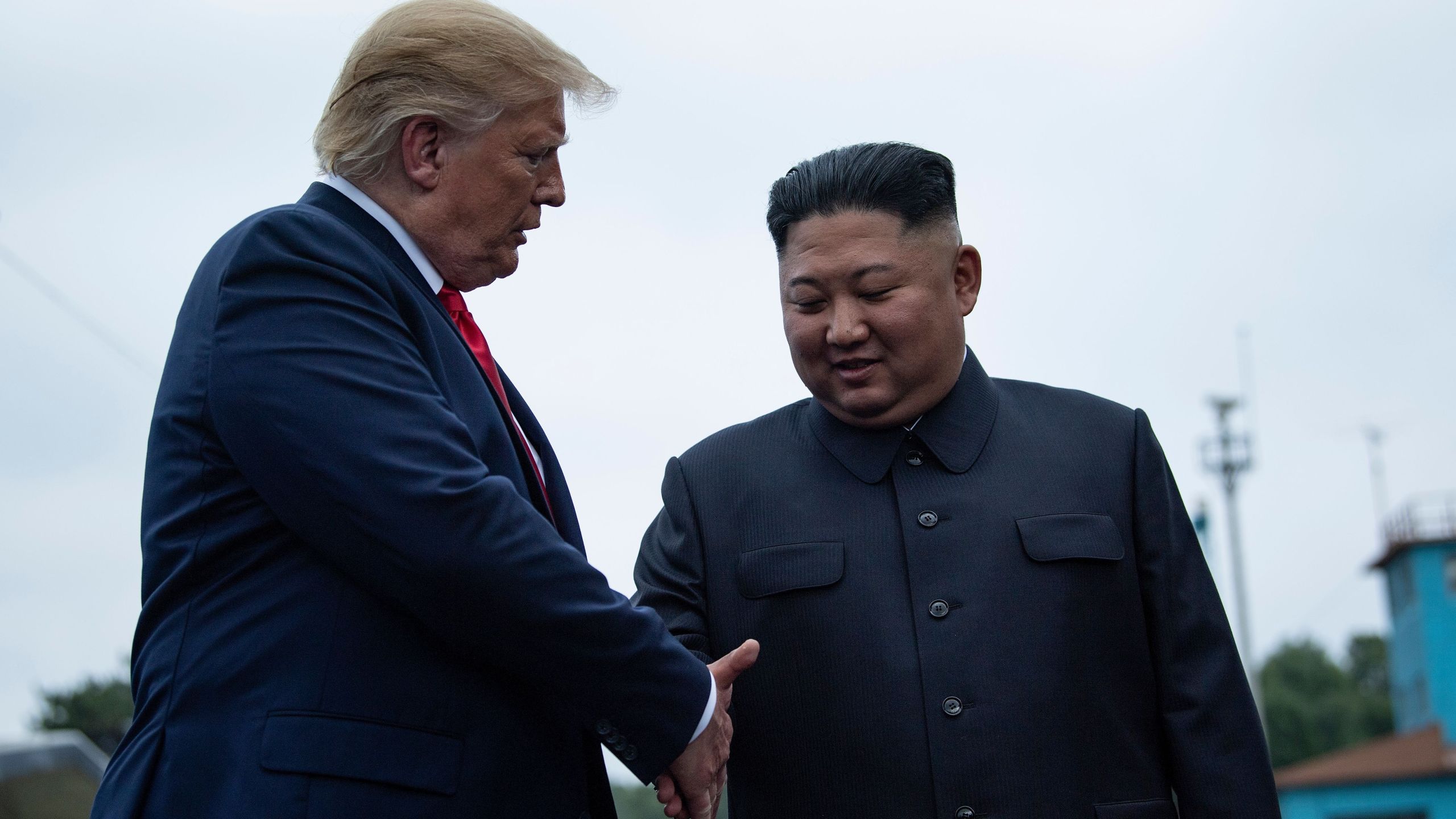 U.S. President Donald Trump and North Korea's leader Kim Jong-un shake hands before a meeting in the Demilitarized Zone (DMZ) on June 30, 2019. (Credit: BRENDAN SMIALOWSKI/AFP/Getty Images)