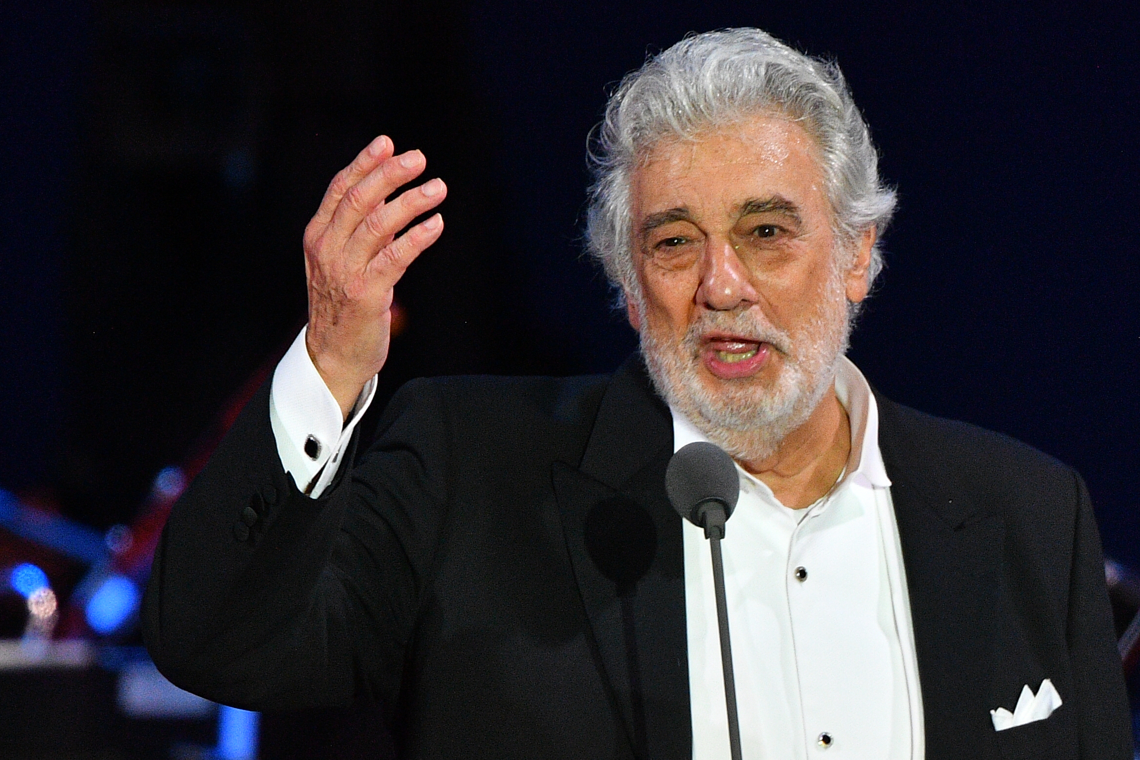 Spanish tenor Placido Domingo gestures as he performs during his concert in the newly inaugurated sports and culture centre 'St Gellert Forum' in Szeged, southern Hungary, on Aug. 28, 2019. (Credit: ATTILA KISBENEDEK/AFP/Getty Images)