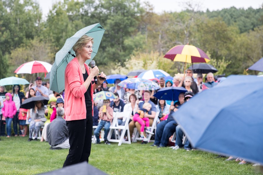 Sen. Elizabeth Warren speaks to a crowd of around 800 as it begins to rain during a Labor Day house party in Hampton Falls, New Hampshire, on Sept. 2, 2019. (Credit: Scott Eisen / Getty Images)