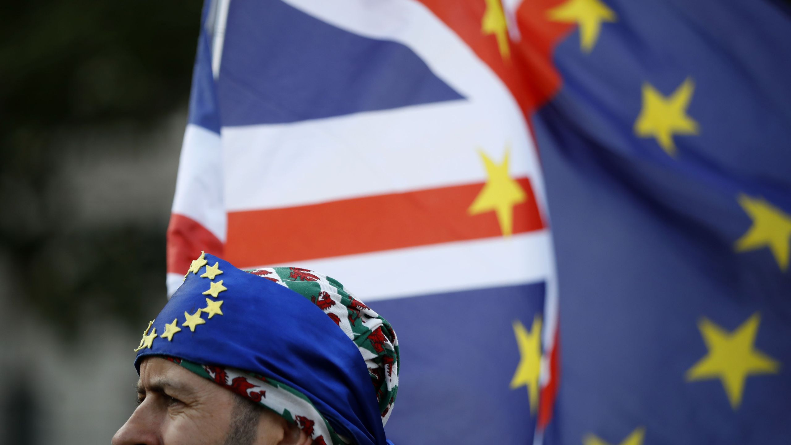 An activist wears a bandana of EU colors at a cross-party rally organized by the People's Vote organization campaigning for a second EU referendum, outside the Houses of Parliament in central London, on Sept. 4, 2019. (Credit: Tolga Akmen / AFP / Getty Images)