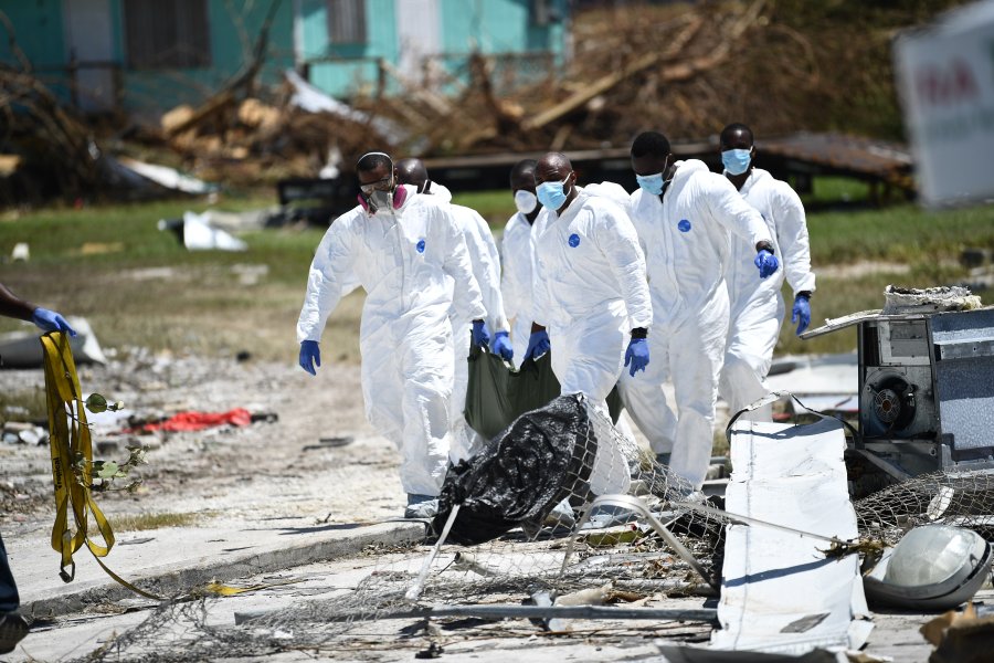 Rescue workers recover the body of a victim of Hurricane Dorian on September 5, 2019, in Marsh Harbour, Great Abaco Island in the Bahamas. (Credit: BRENDAN SMIALOWSKI/AFP/Getty Images)