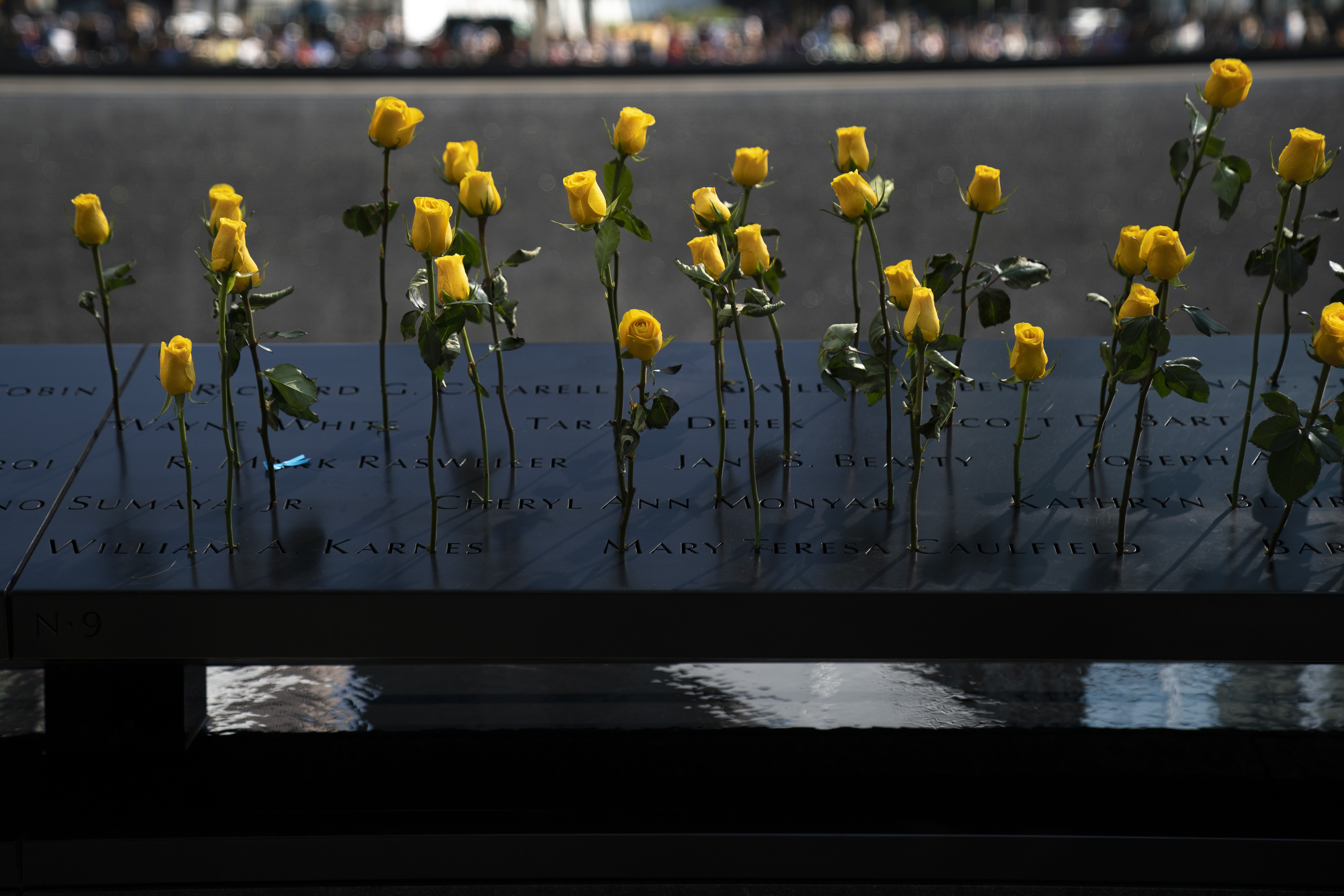 Flowers are left at the National September 11 Memorial on the 18th anniversary of the 9/11 attacks Sept. 11, 2019, in New York City. (Credit: Drew Angerer/Getty Images)