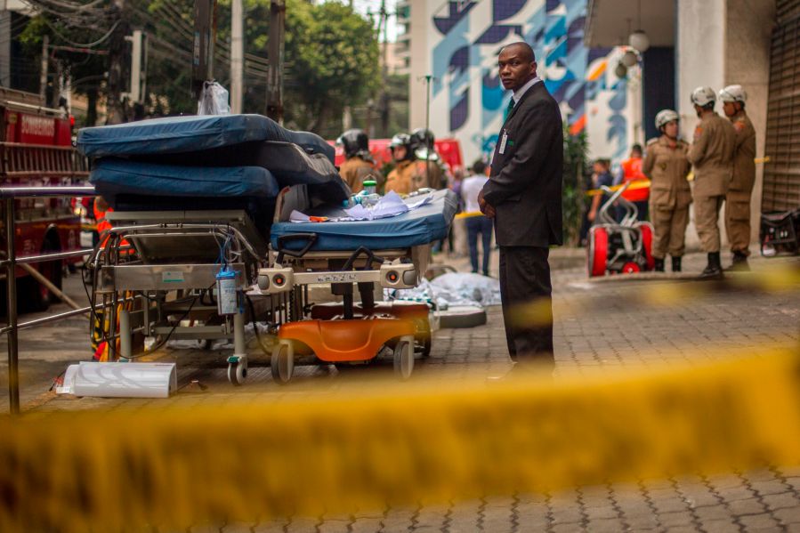 A security officer looks after medical equipment left outside Badim Hospital following a fire at the medical facility in the Tijuca neighborhood, Rio de Janeiro, Brazil, on Sept. 13, 2019. (Credit: MAURO PIMENTEL/AFP/Getty Images)