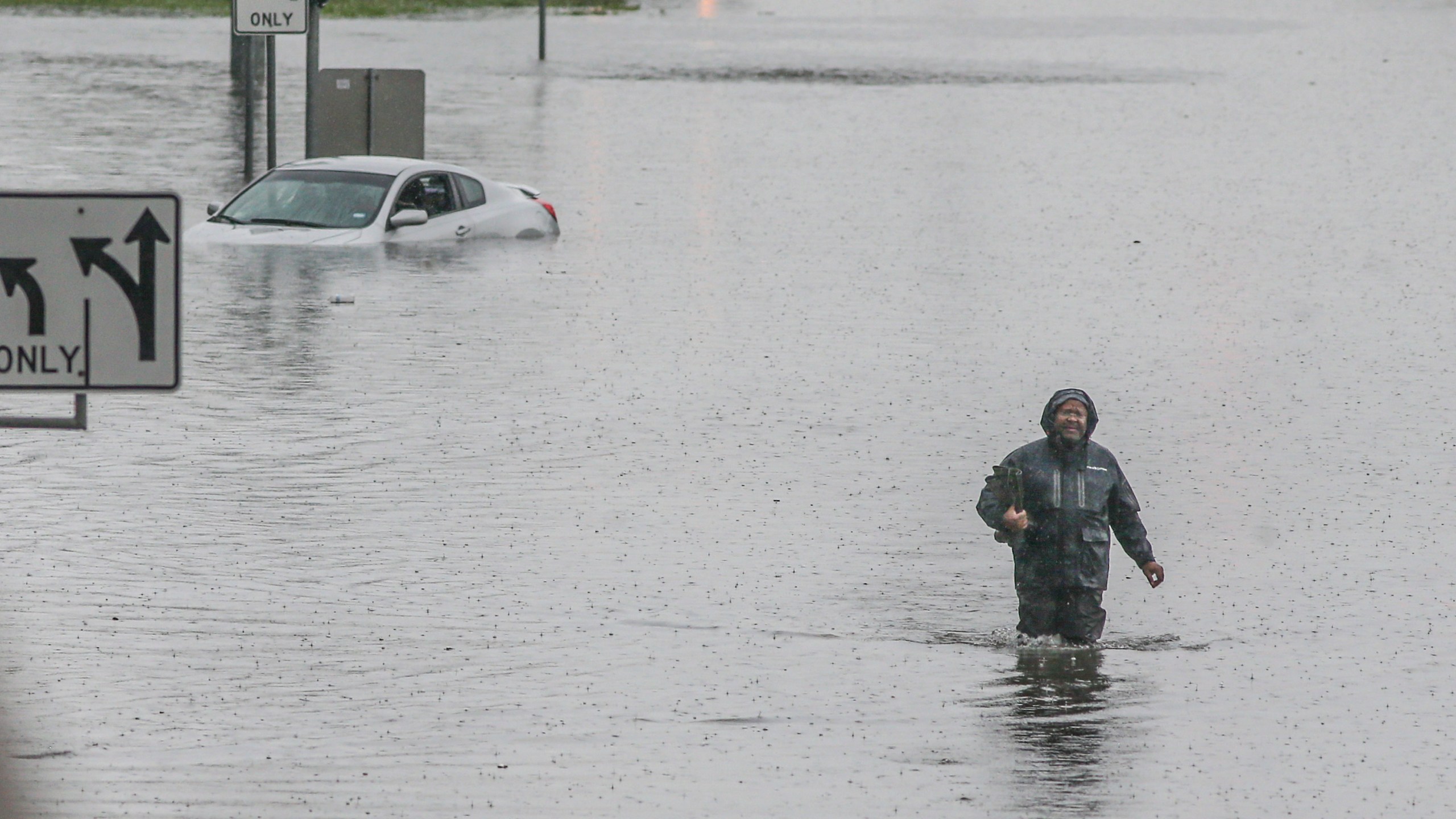 A man walks through the flooded feeder roads off of highway 69 North on September 19, 2019 in Houston, Texas. (Credit: Thomas B. Shea/Getty Images)