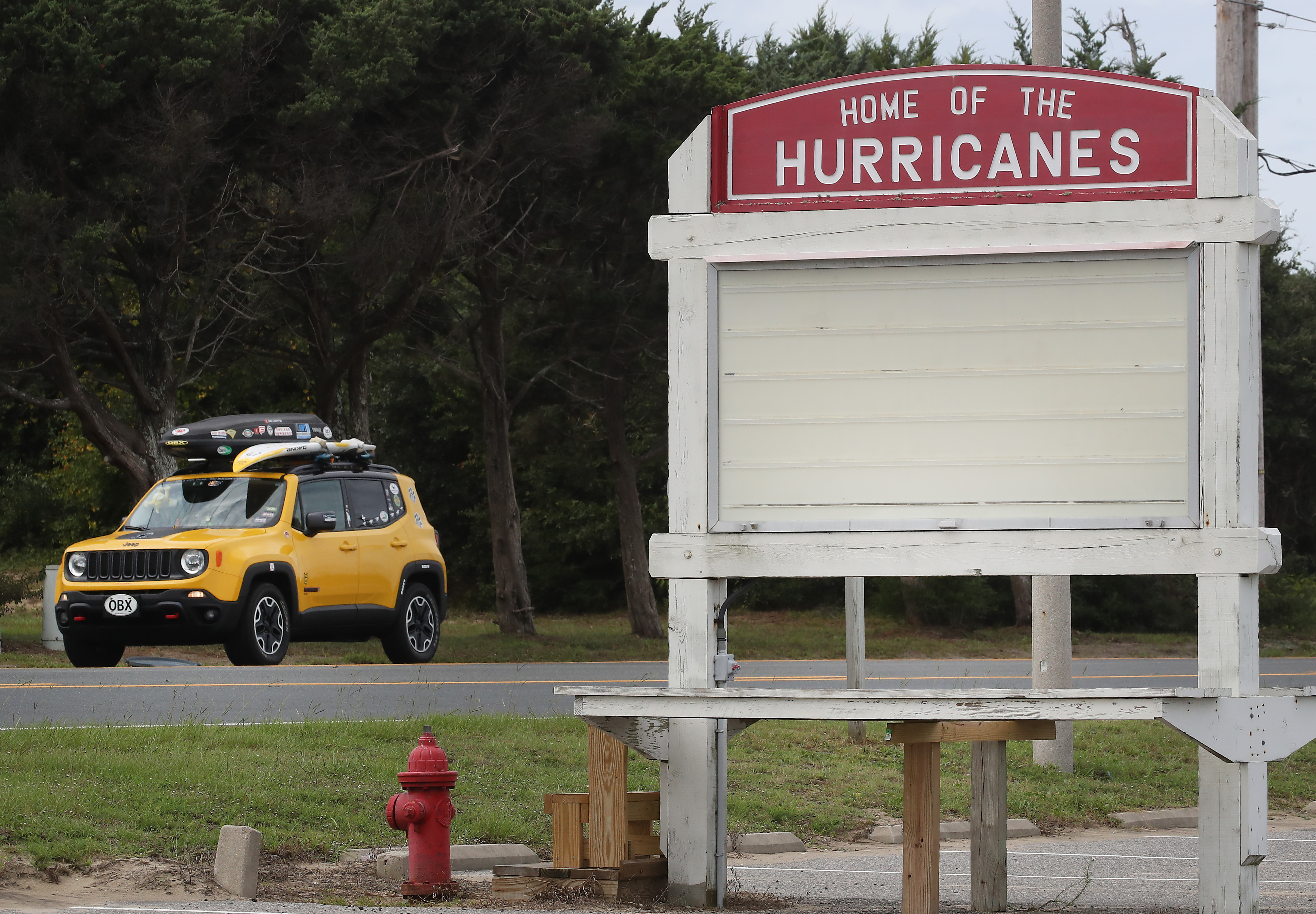 A vehicle drives past the Cape Hatteras Secondary School, an area under a mandatory evacuation due to approaching Hurricane Dorian on September 5, 2019 in Buxton, North Carolina. (Credit: Mark Wilson/Getty Images)