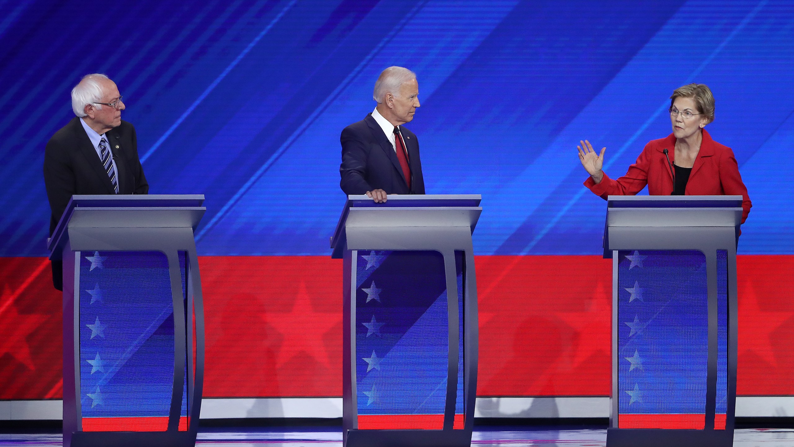 Democratic presidential candidates Sen. Bernie Sanders (I-VT) and former Vice President Joe Biden look on as Sen. Elizabeth Warren (D-MA) speaks during the Democratic Presidential Debate at Texas Southern University's Health and PE Center on Sept. 12, 2019, in Houston, Texas. (Credit: Win McNamee/Getty Images)