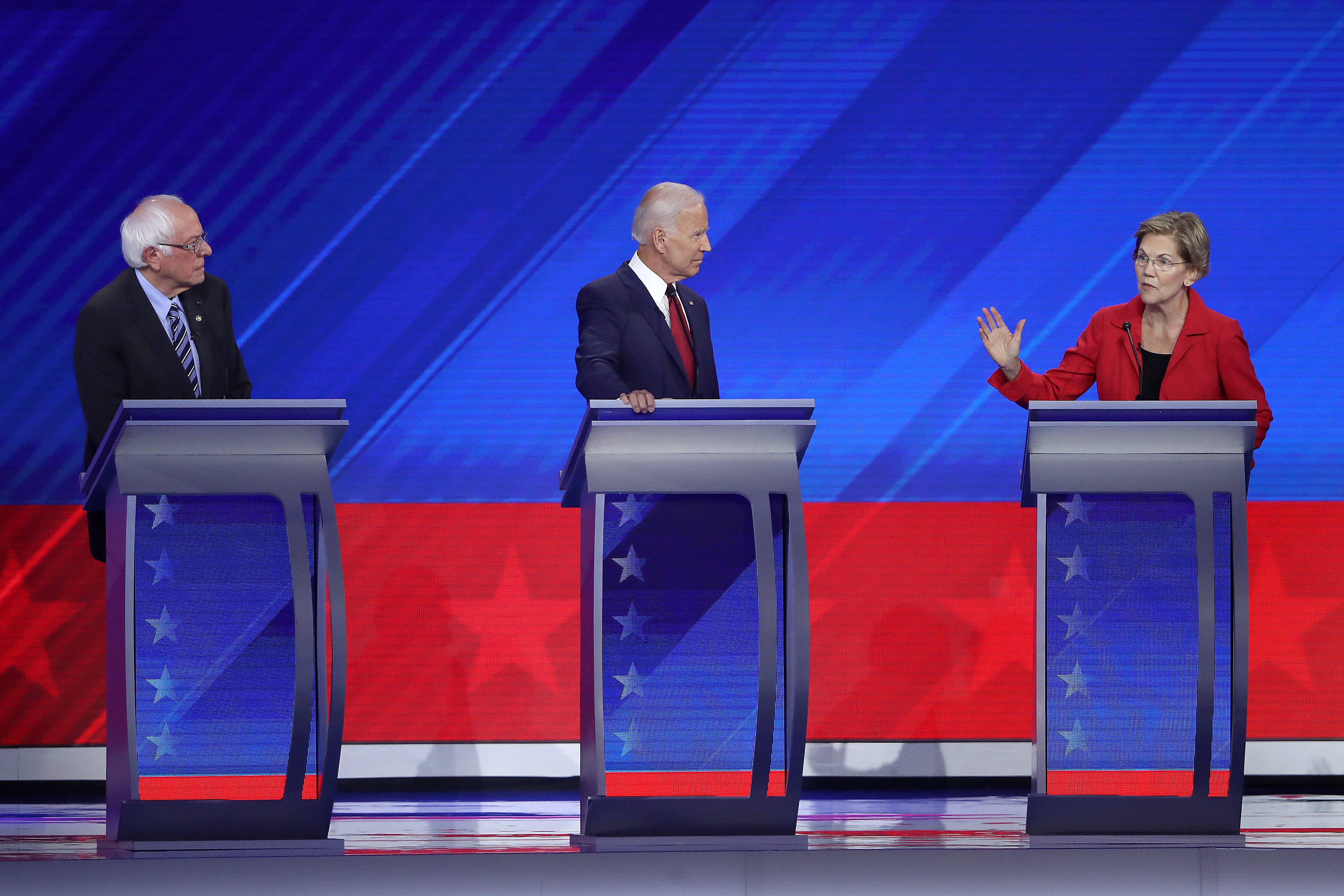 Democratic presidential candidates Sen. Bernie Sanders (I-VT) and former Vice President Joe Biden look on as Sen. Elizabeth Warren (D-MA) speaks during the Democratic Presidential Debate at Texas Southern University's Health and PE Center on Sept. 12, 2019, in Houston, Texas. (Credit: Win McNamee/Getty Images)