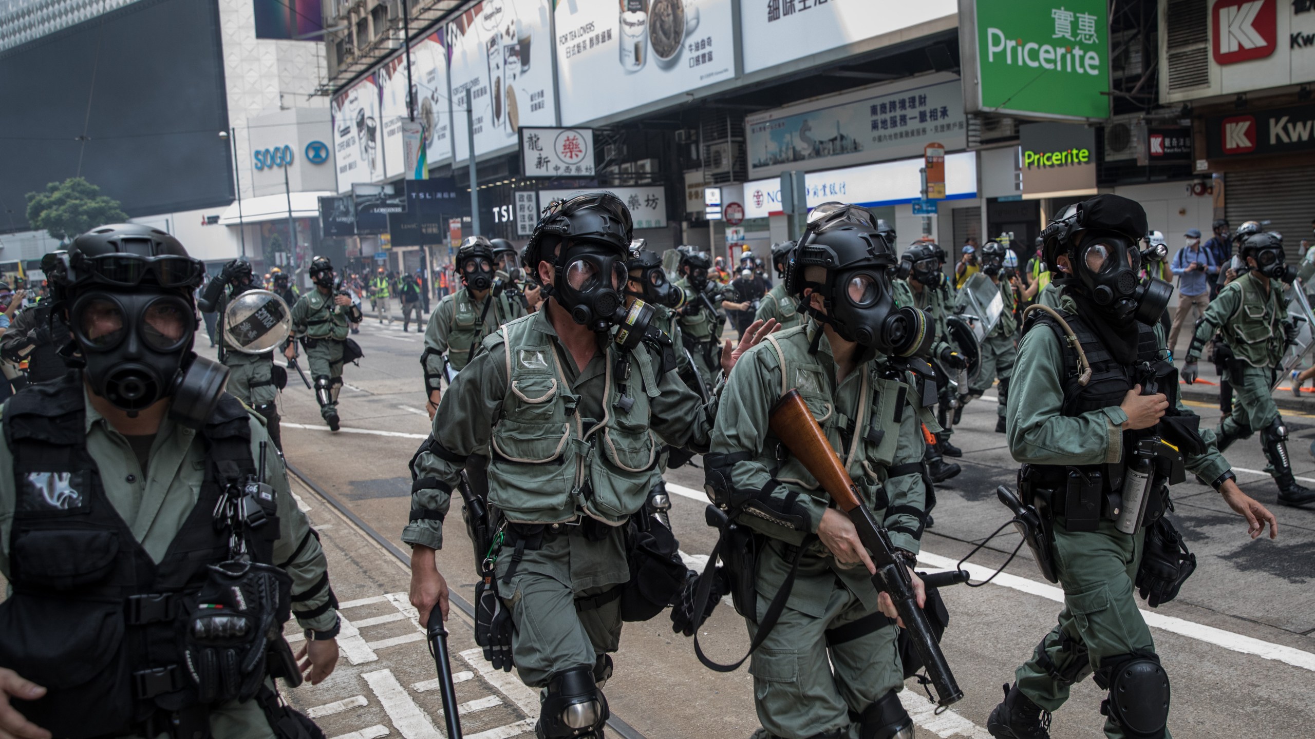 Police run down a street to disperse pro-democracy protesters ahead of a march on September 29, 2019 in Hong Kong, China. (Credit: Chris McGrath/Getty Images)