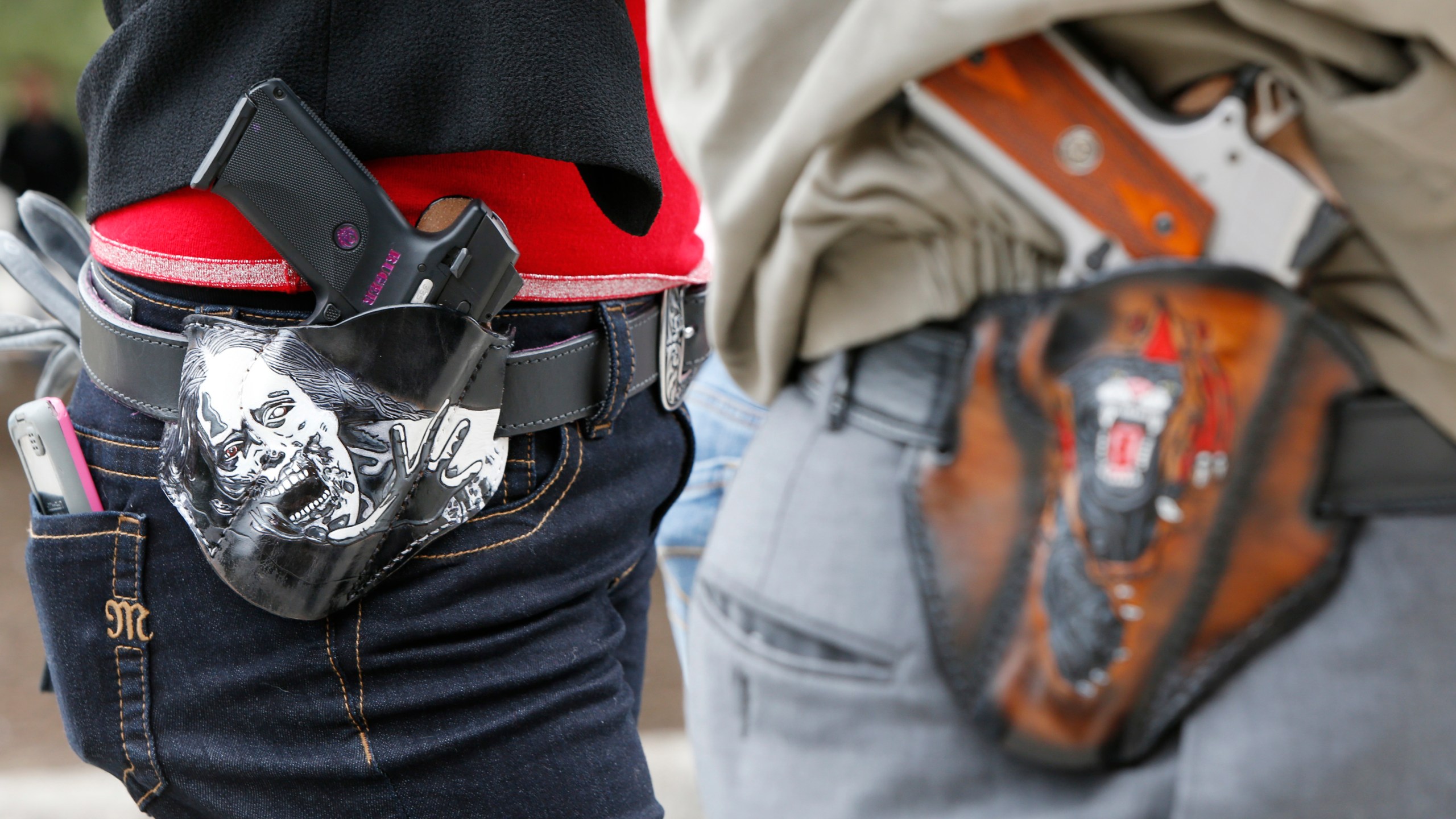 Art and Diana Ramirez of Austin with their pistols in custom-made holsters during an open-carry rally at the Texas State Capitol on Jan. 1, 2016 in Austin, Texas. (Credit: Erich Schlegel/Getty Images)