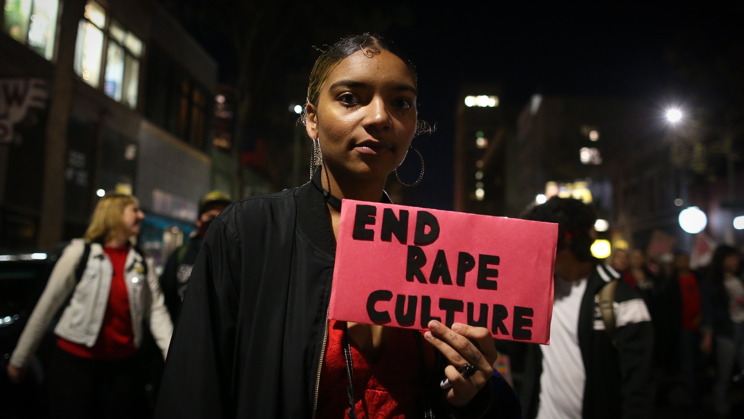 A woman holds a sign reading "End Rape Culture" during a march for International Women's Day on March 8, 2017, in Oakland, California. (Credit: Elijah Nouvelage/Getty Images)