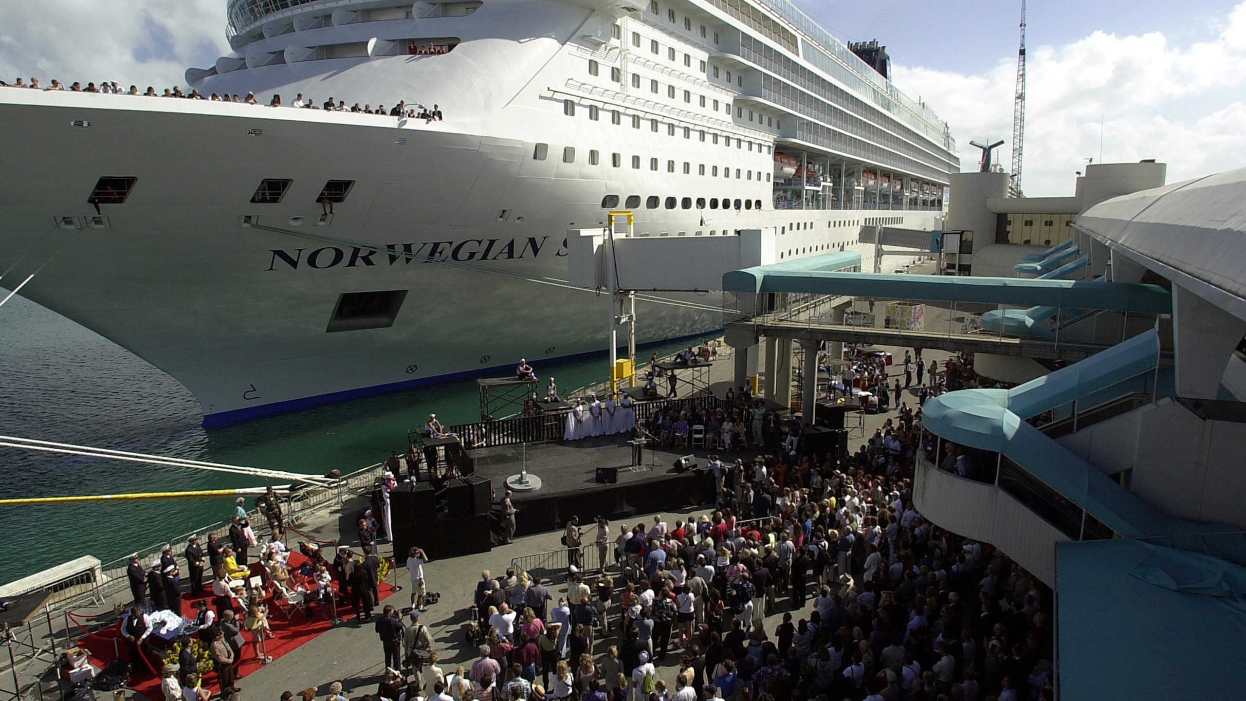 Crowds gather to watch a dual christening ceremony for Norwegian Cruise Lines ships November 17, 2001 at the port of Miami. (Credit: Getty Images)