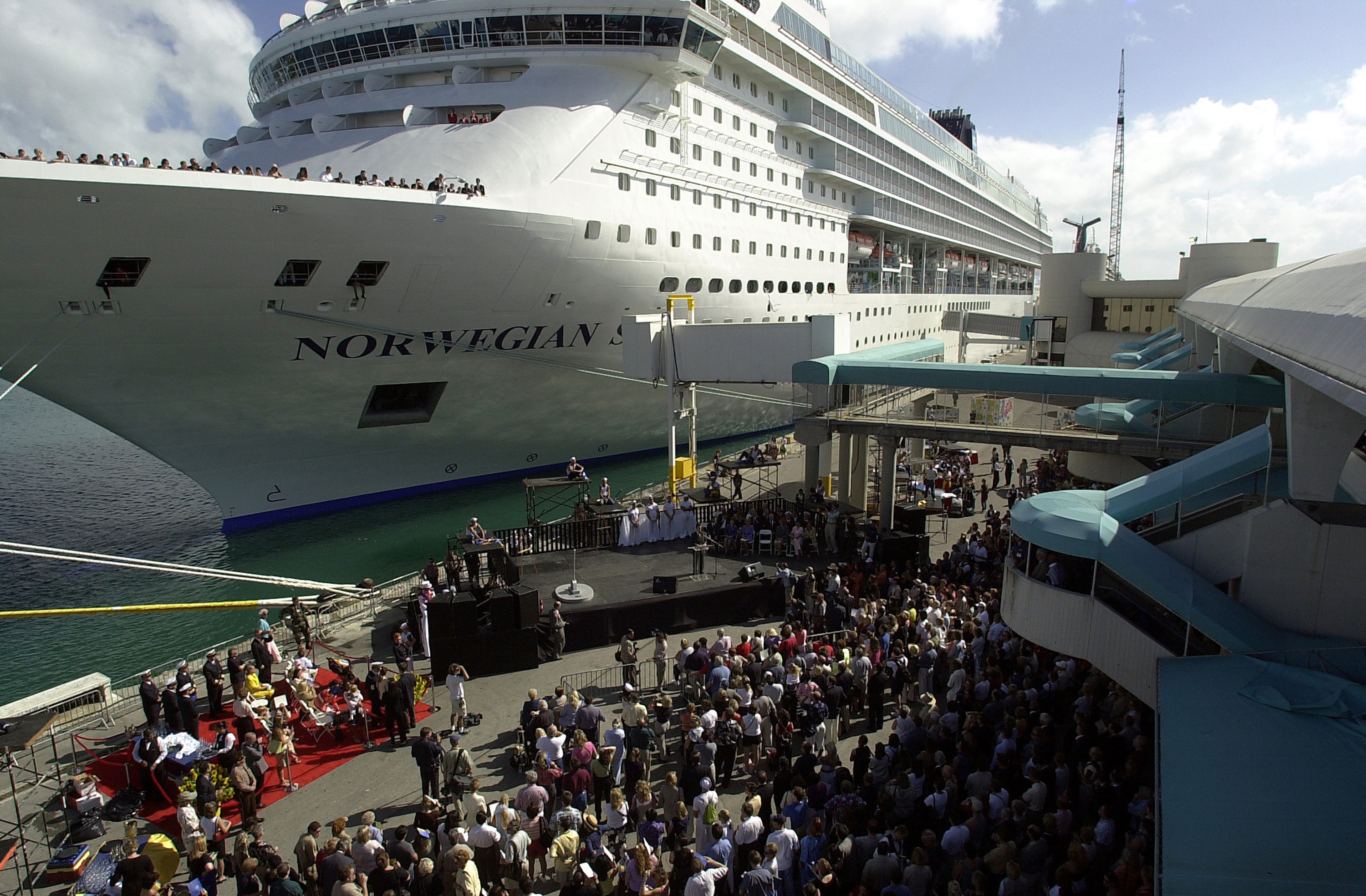 Crowds gather to watch a dual christening ceremony for Norwegian Cruise Lines ships November 17, 2001 at the port of Miami. (Credit: Getty Images)