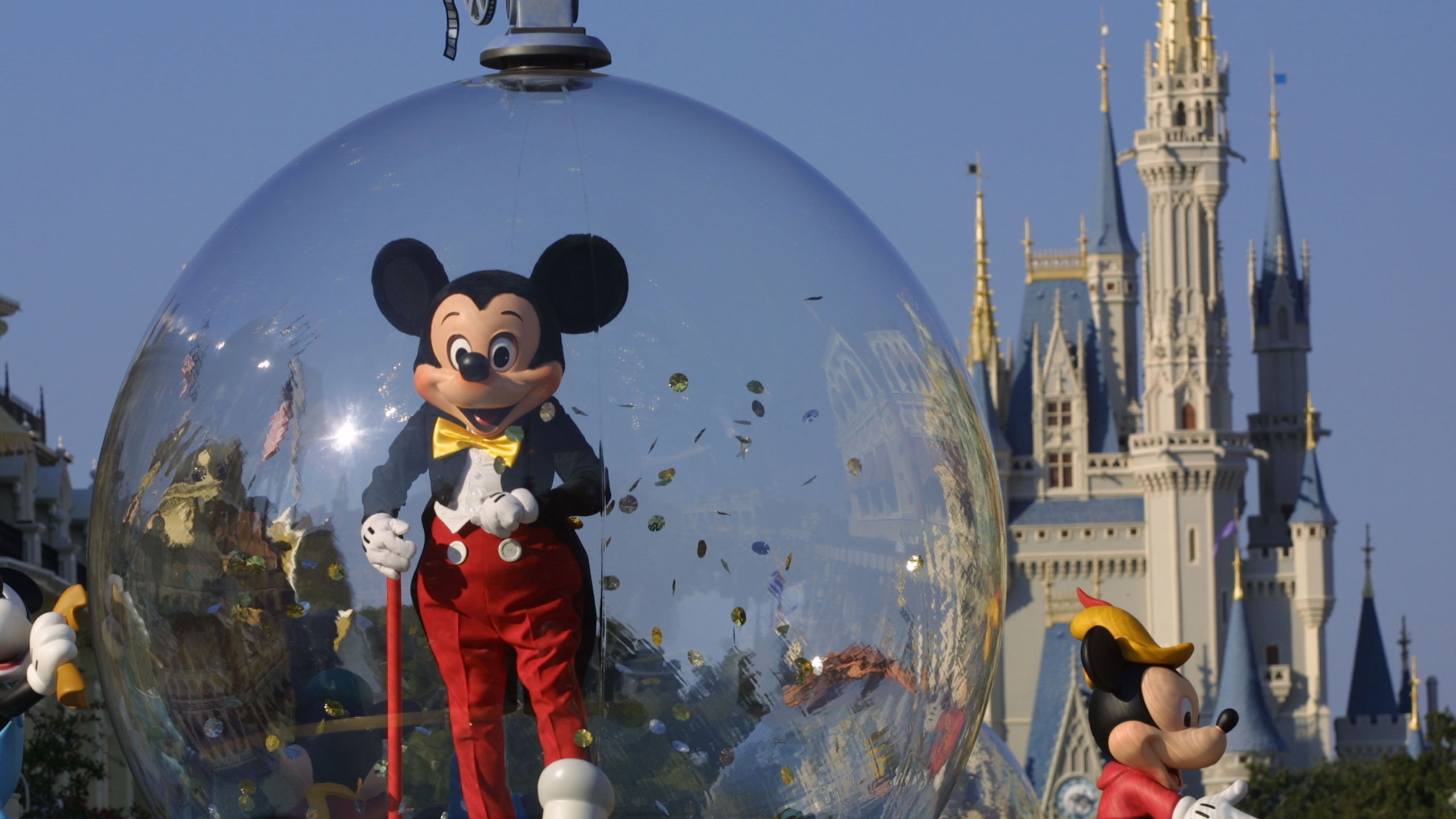 Mickey Mouse rides in a parade through Main Street with Cinderella's castle in the background at Disney World's Magic Kingdom in Orlando on Nov. 11, 2001. (Joe Raedle / Getty Images)