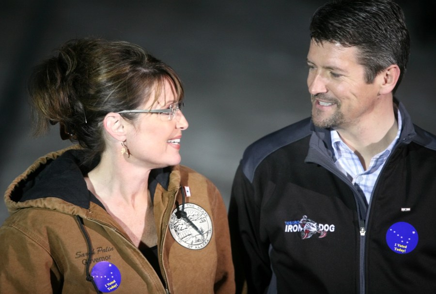 Republican vice-presidential nominee Alaska Gov. Sarah Palin and her husband Todd Palin exchange a glance while speaking with members of the media after casting their votes November 4, 2008 in Wasilla, Alaska. (Credit: Johnny Wagner/Getty Images)