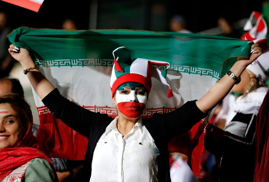 An Iranian woman watches the World Cup soccer match between Portugal and Iran at Azadi stadium in Tehran on June 25, 2018.(Credit: Atta Kenare/AFP/Getty Images)