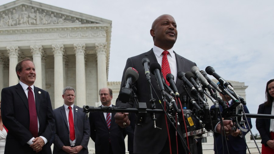 Indiana Attorney General Curtis Hill speaks as Washington, D.C. Attorney General Karl Racine (L) and Texas Attorney General Ken Paxton (2nd L) listen during a news conference in front of the U.S. Supreme Court Sept. 9, 2019, in Washington, D.C. (Credit: Alex Wong/Getty Images)