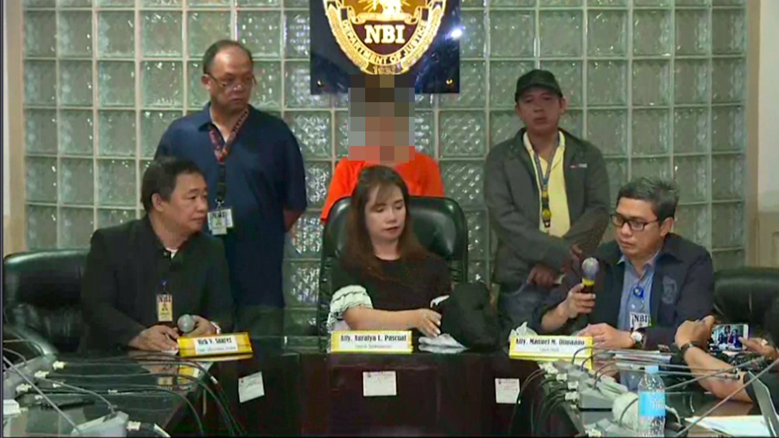 Press conference by the Philippines National Bureau of Investigation on Thursday. The 43-year-old American woman stands in the background. (Credit: CNN Philippines)