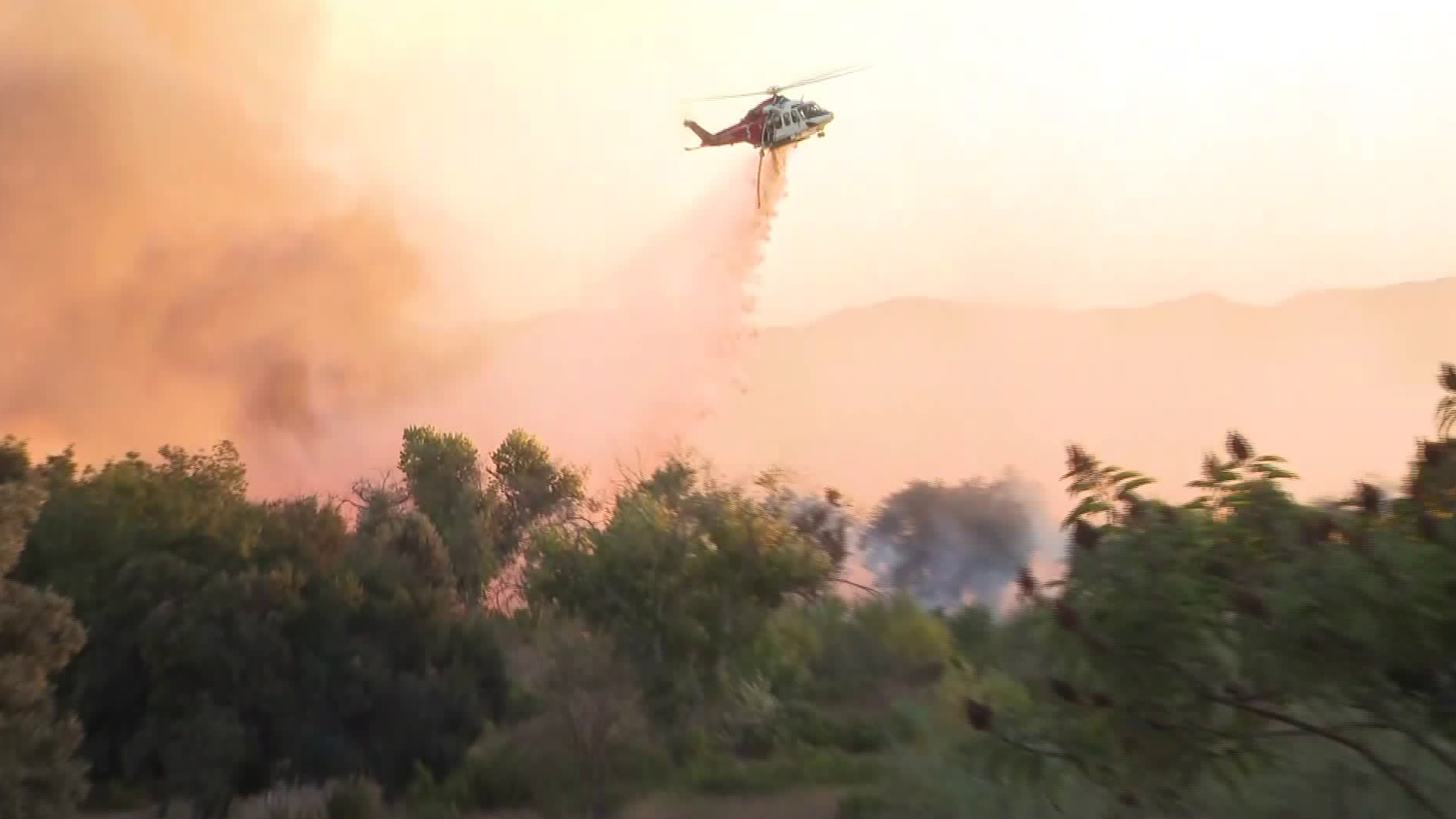 A helicopter drops water on the Sepulveda Fire in the Sepulveda Basin on Oct. 24, 2019. (Credit: KTLA)