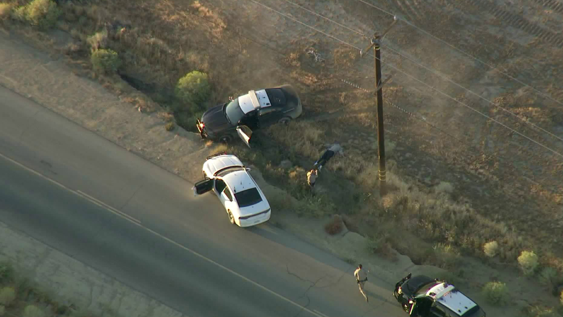 A man who stole a CHP vehicle during a wild pursuit in the Antelope Valley is surrenders to police west of Rosamond on Oct. 2, 2019. (Credit: KTLA)