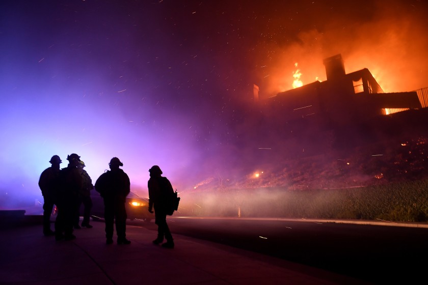 Firefighters monitor a house fully engulfed on Mountain Crest Circle in Thousand Oaks during the 2018 Woolsey Fire.(Credit: Wally Skalij/Los Angeles Times)