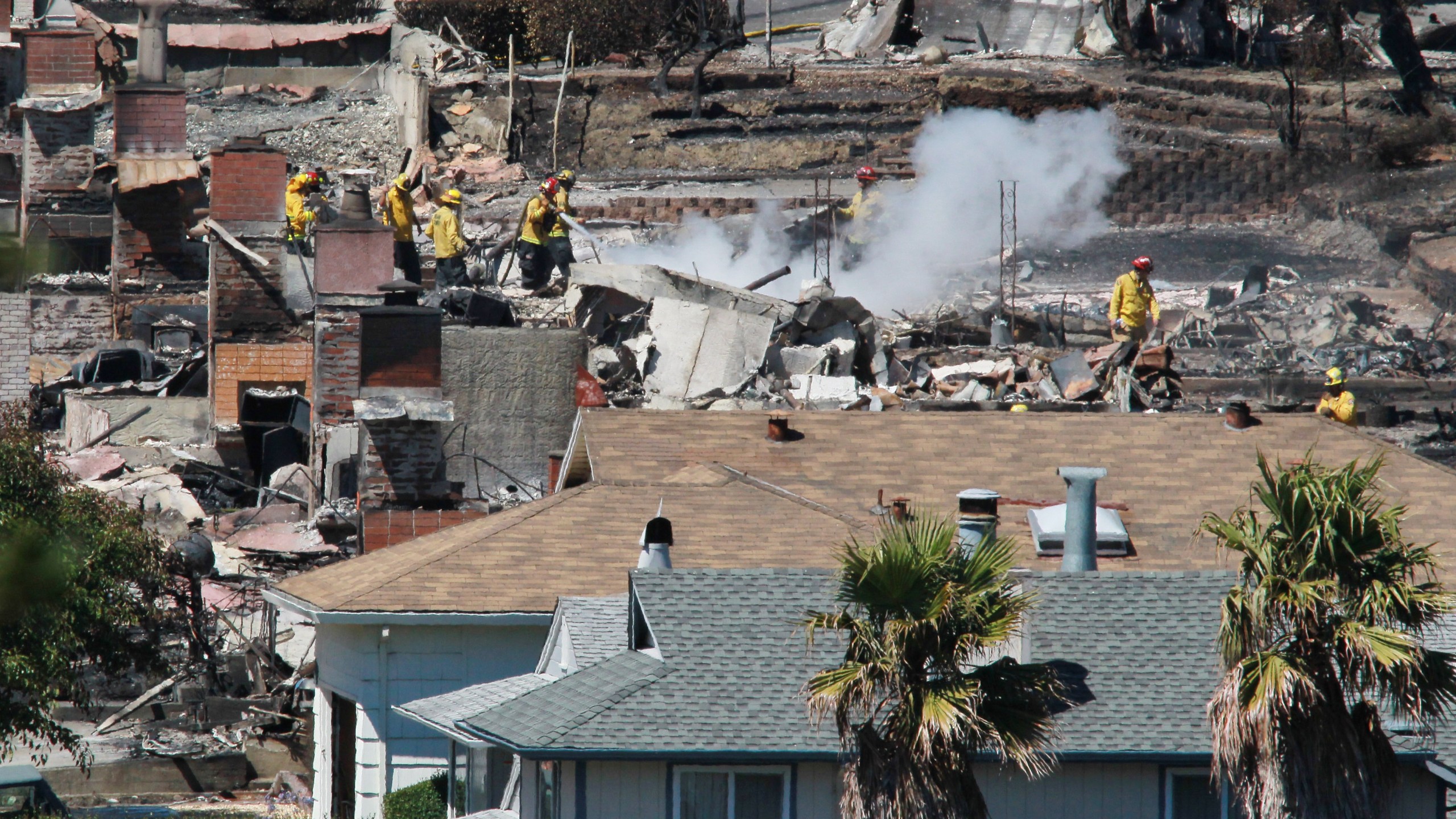 Firefighters sift through rubble at a burned home that was destroyed by a massive explosion and fire on Sep. 10, 2010, in San Bruno, California.(Credit: Justin Sullivan/Getty Images)