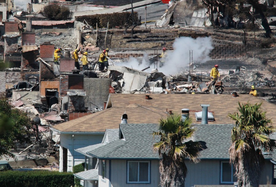 Firefighters sift through rubble at a burned home that was destroyed by a massive explosion and fire on Sep. 10, 2010, in San Bruno, California.(Credit: Justin Sullivan/Getty Images)