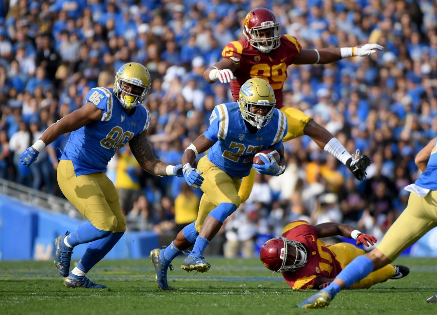 Joshua Kelley of the UCLA Bruins runs with Devin Asiasi during a match at the Rose Bowl on Nov. 17, 2018 in Pasadena. (Credit: Harry How/Getty Images)