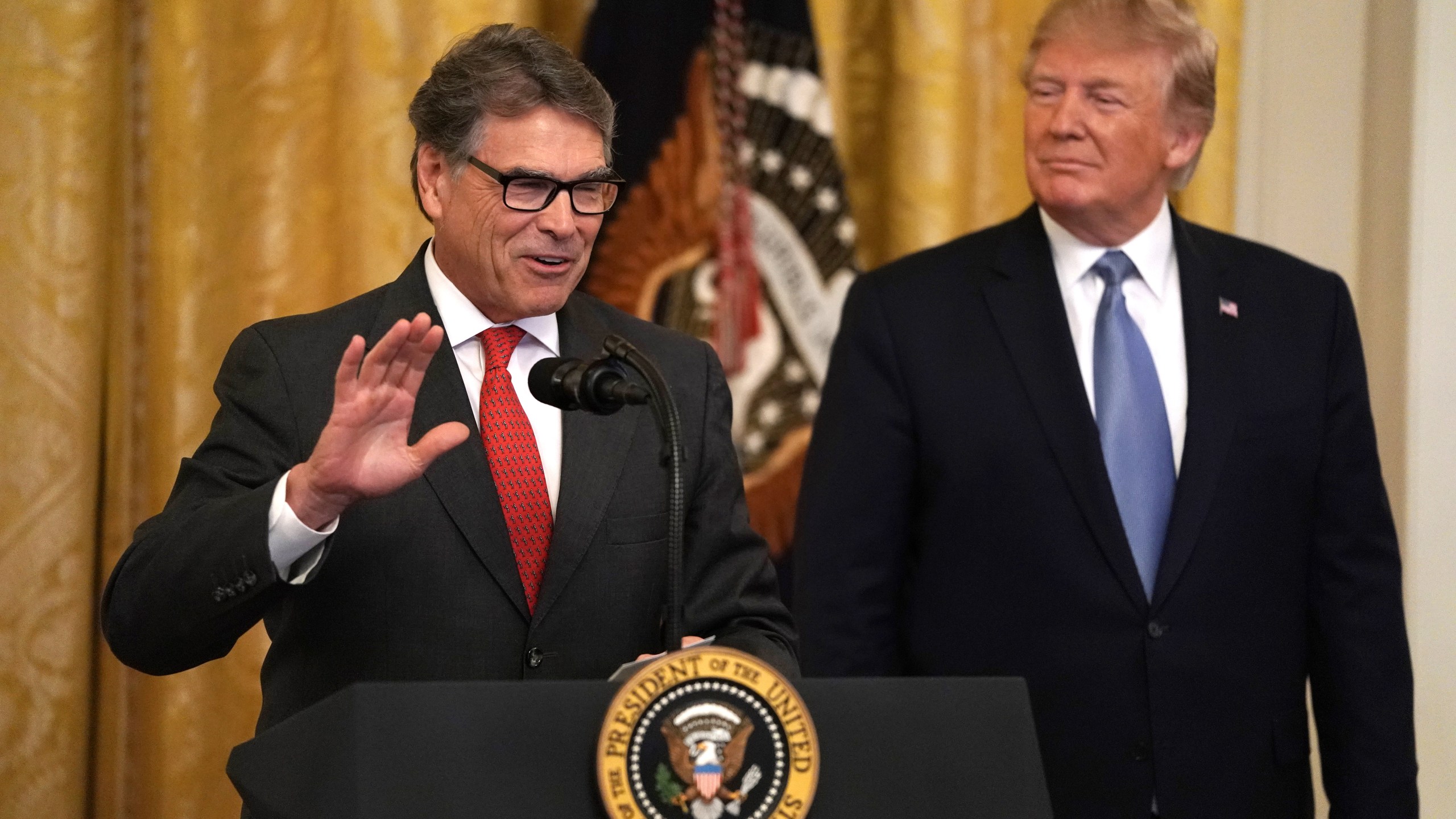 U.S. Secretary of Energy Rick Perry speaks as President Donald Trump looks on during an East Room event on the environment, July 7, 2019, at the White House in Washington, D.C. (Credit: Alex Wong/Getty Images)