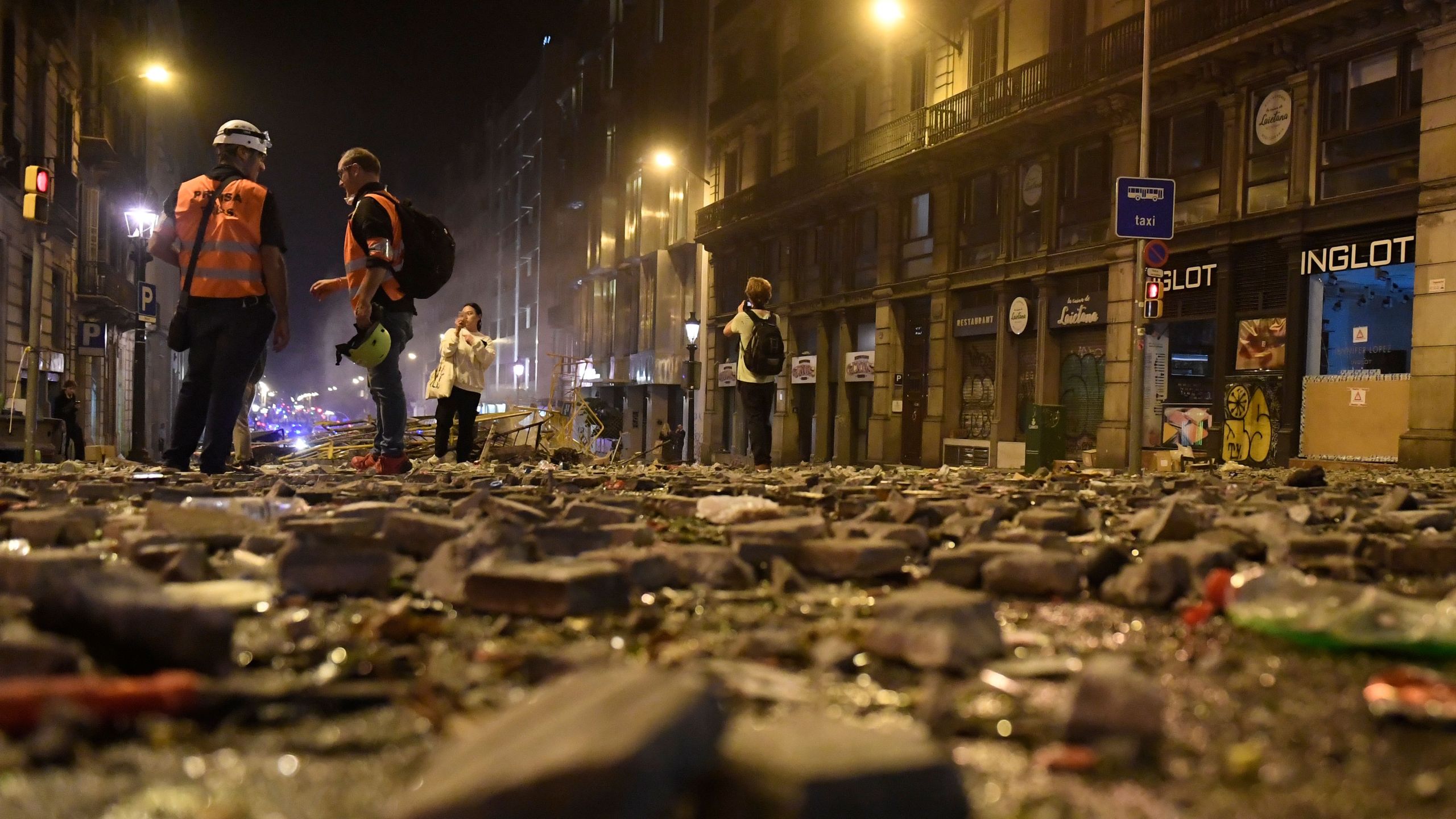 Debris is seen on a street of Barcelona, on Oct. 18, 2019, after violence escalated during clashes, with radical separatists hurling projectiles at police, who responded with teargas and rubber bullets sparking scenes of chaos in the city centre.(Credit: JOSEP LAGO/AFP via Getty Images)