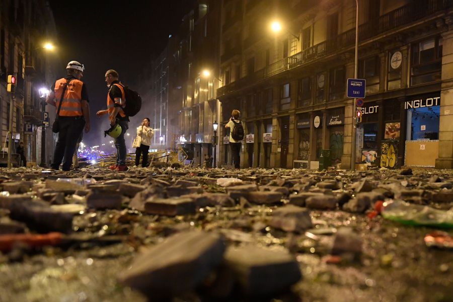 Debris is seen on a street of Barcelona, on Oct. 18, 2019, after violence escalated during clashes, with radical separatists hurling projectiles at police, who responded with teargas and rubber bullets sparking scenes of chaos in the city centre.(Credit: JOSEP LAGO/AFP via Getty Images)