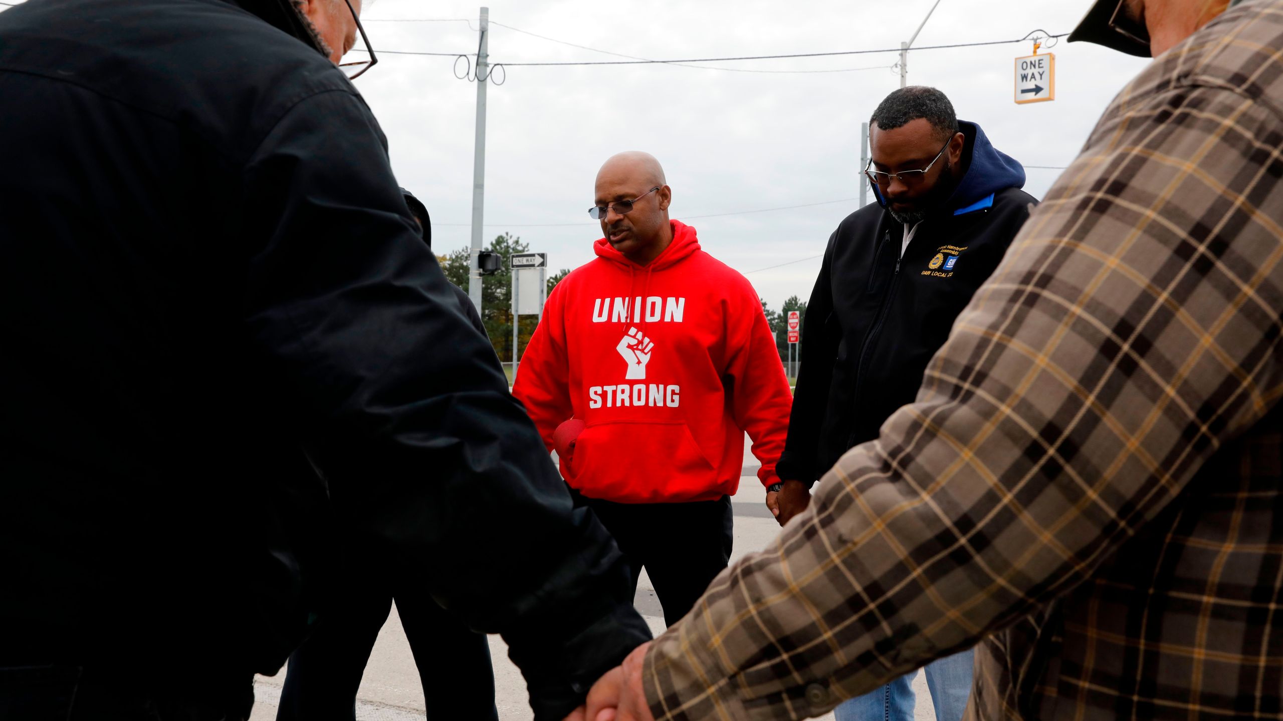 United Auto Workers member Joe Ryan, center, leads a prayer circle to recite a strike closing prayer outside of the General Motors Detroit-Hamtramck Assembly plant in Detroit, Michigan, on Oct. 25, 2019. (Credit: Jeff Kowalsky / AFP / Getty Images)