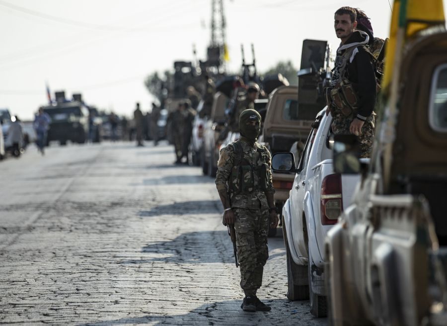 Fighters from the Syrian Democratic Forces gather in their military vehicles as they withdraw from the Sanjak Saadoun border area near the northern Syrian town of Amuda, on Oct. 27, 2019. (Credit: SOULEIMAN/AFP via Getty Images)