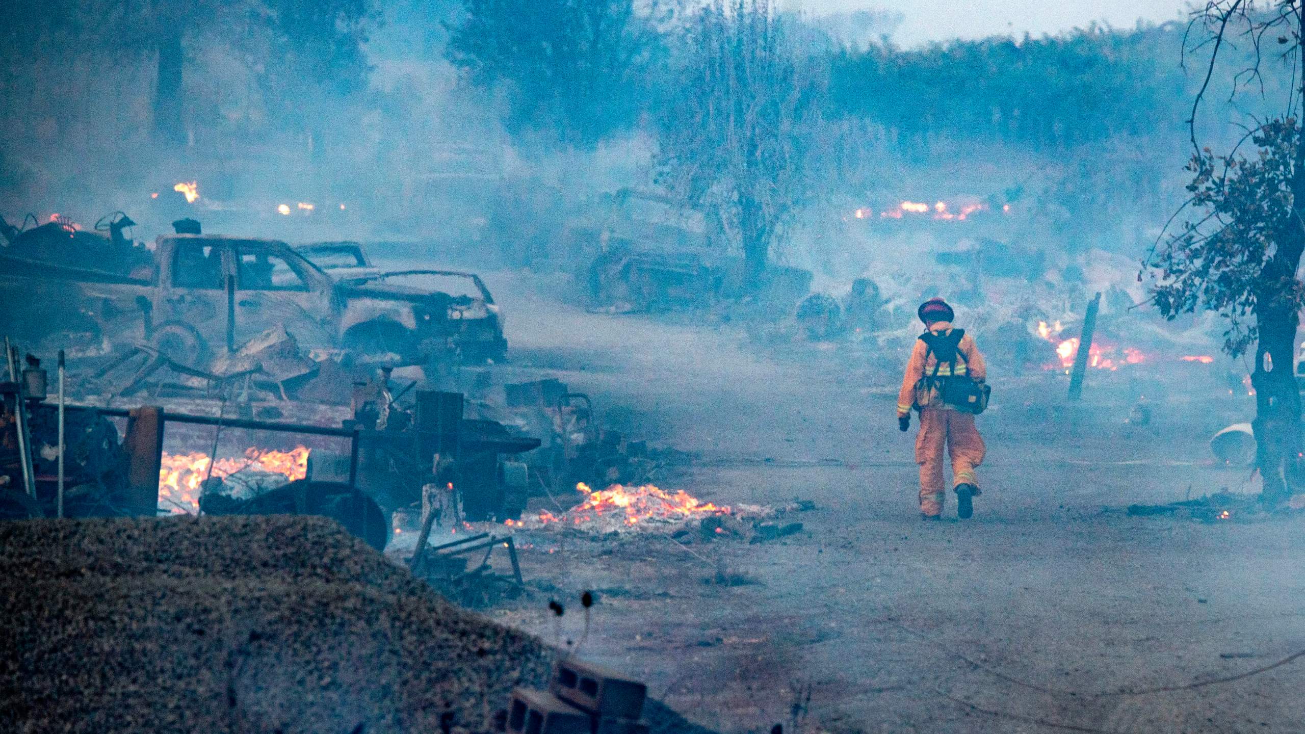 A firefighter walks through a burned property after the Kincade fire tore through Healdsburg, California on Oct. 27, 2019. (Credit: JOSH EDELSON/AFP via Getty Images)