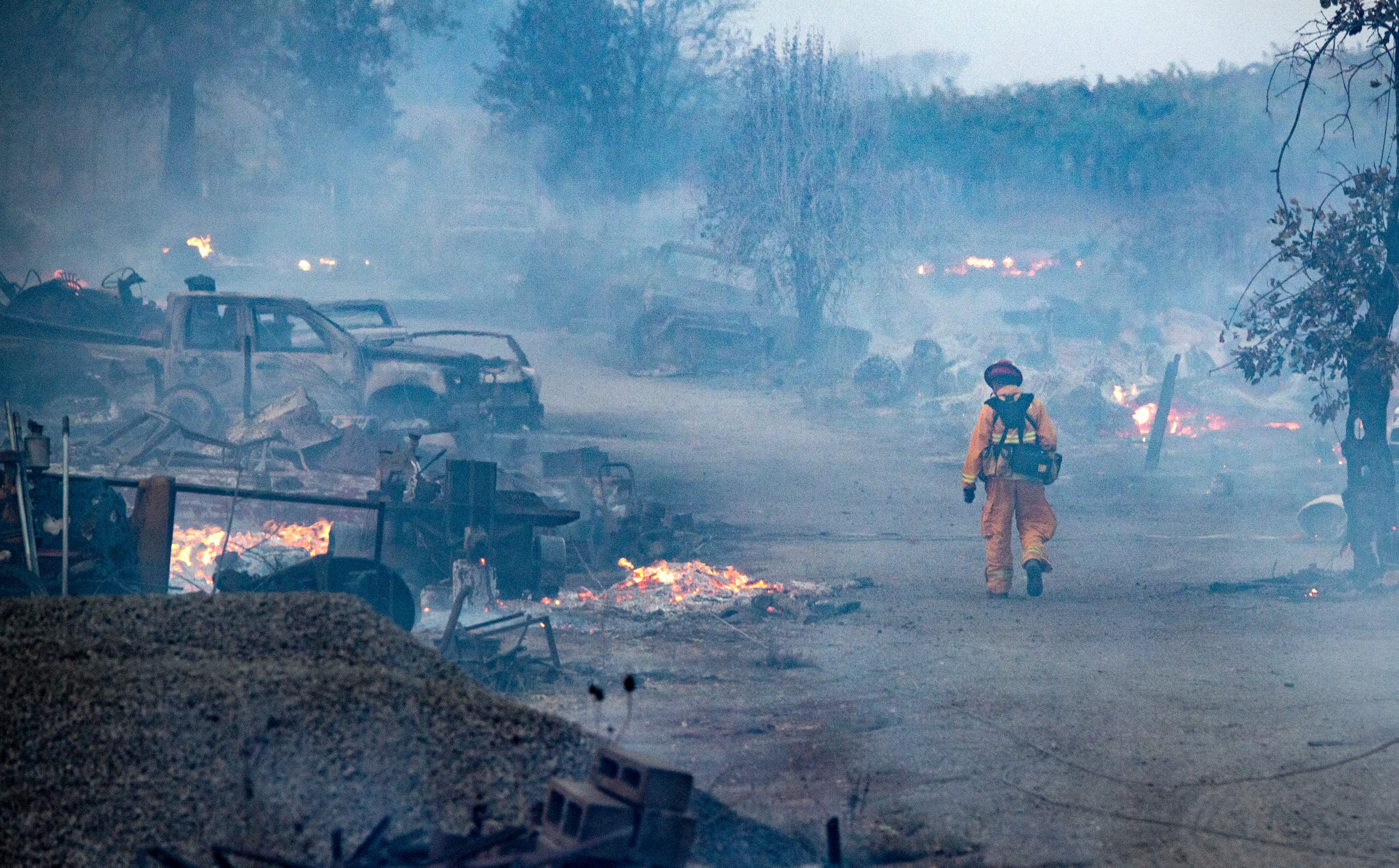 A firefighter walks through a burned property after the Kincade fire tore through Healdsburg, California on Oct. 27, 2019. (Credit: JOSH EDELSON/AFP via Getty Images)