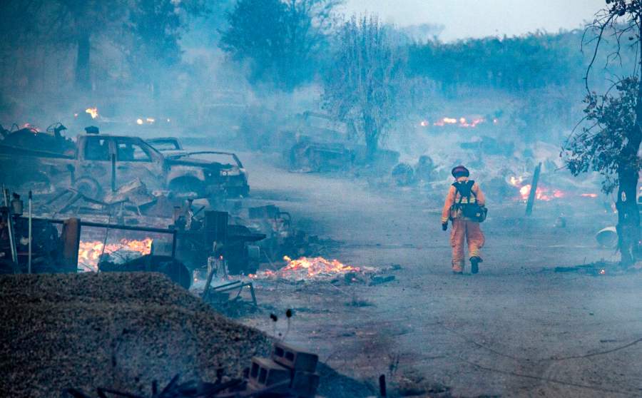 A firefighter walks through a burned property after the Kincade fire tore through Healdsburg, California on Oct. 27, 2019. (Credit: JOSH EDELSON/AFP via Getty Images)