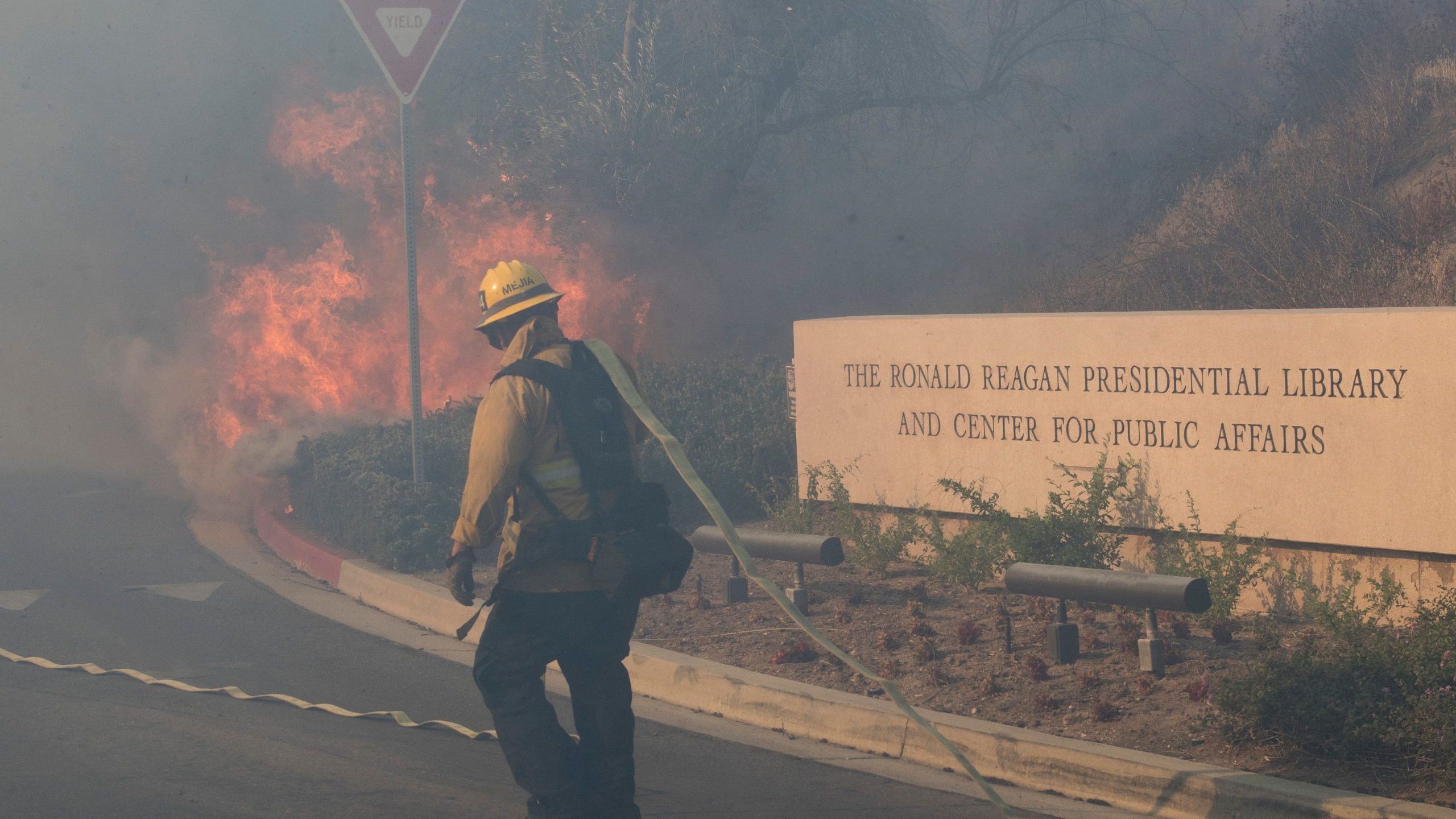 Firefighters battle to protect the Reagan Library from the Easy Fire in Simi Valley on Oct. 30, 2019. (Credit: MARK RALSTON/AFP via Getty Images)