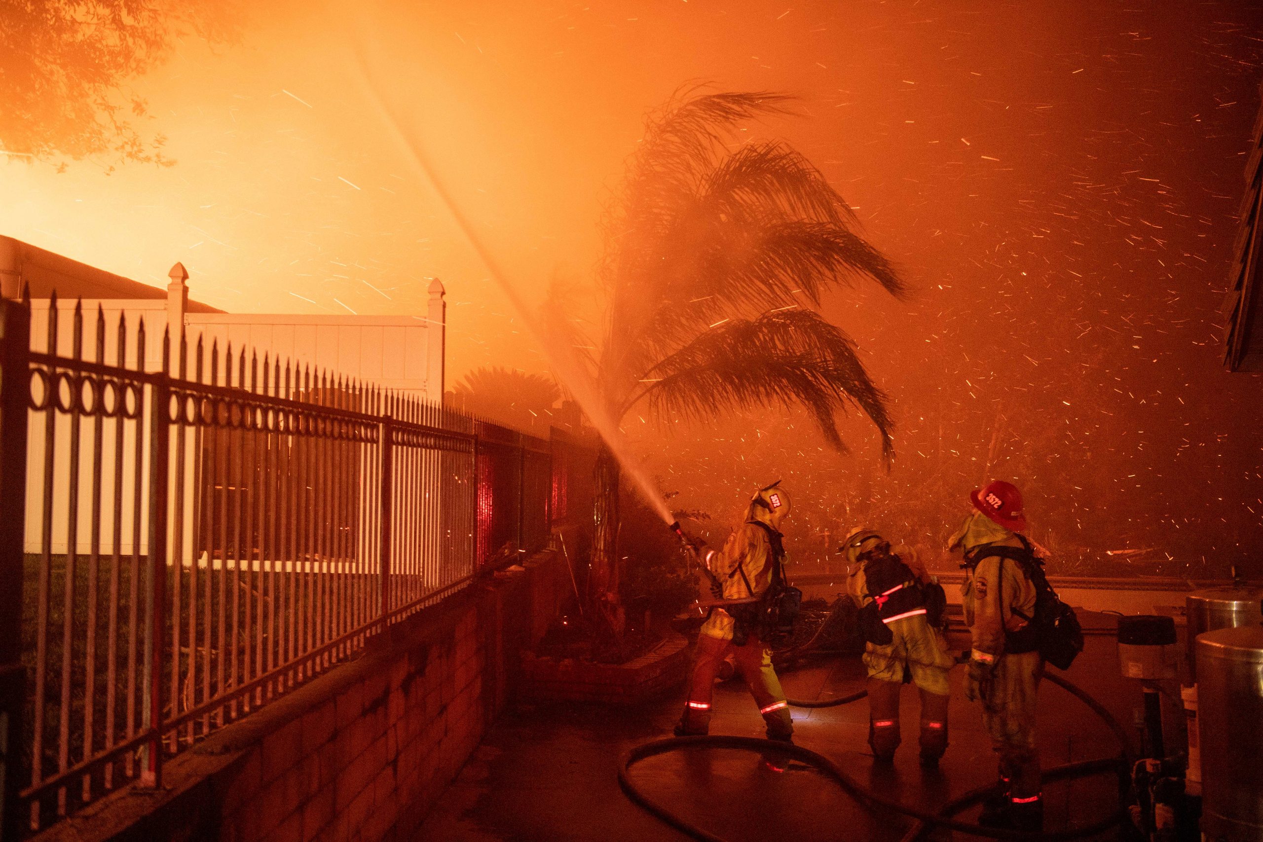 Firefighters battle wind-whipped flames engulfing multiple homes during the Hillside Fire in the North Park neighborhood of San Bernardino on Oct. 31, 2019. (Credit: Josh Edelson / AFP / Getty Images)