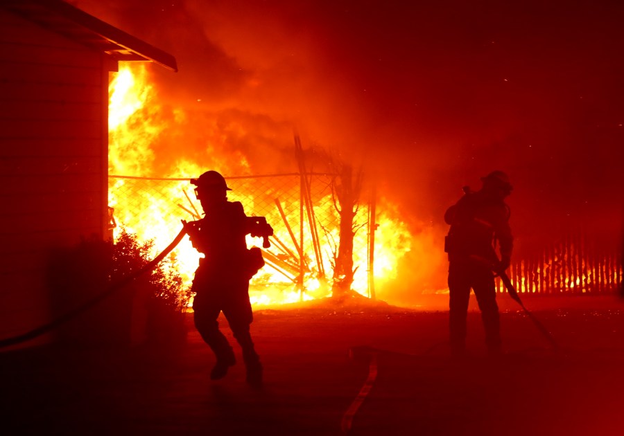 Firefighters battle the Kincade Fire as it burns a barn on Oct. 27, 2019, in Santa Rosa, Calif. (Credit: Justin Sullivan/Getty Images)