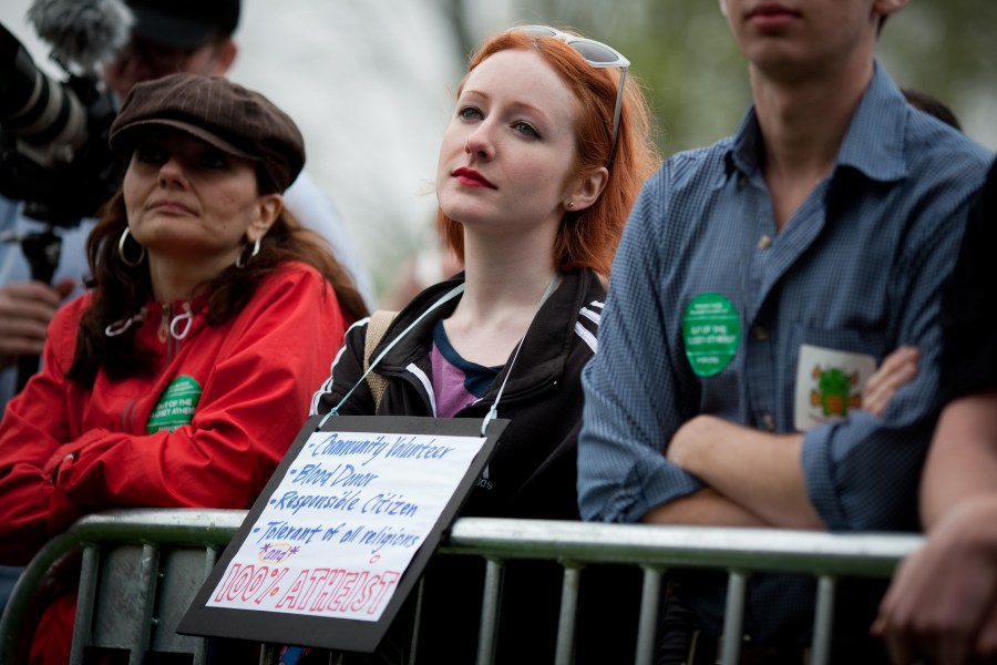 A woman listens to speakers during the National Atheist Organization's "Reason Rally" March 24, 2012 on the National Mall in Washington, D.C. (Credit: Allison Shelley/Getty Images)