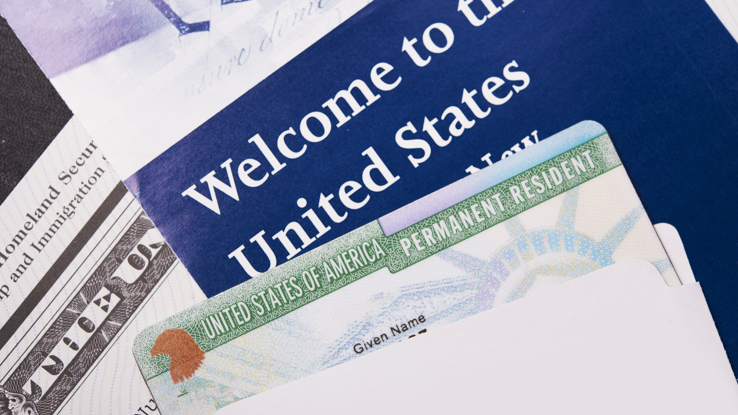 Immigration letters and an enclosed permanent resident card are seen in this undated file photo. (Credit: Getty Images)