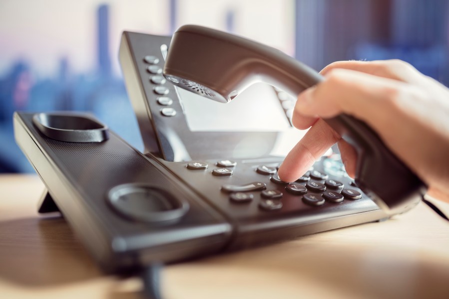 Someone is seen dialing to make a telephone call in this file photo. (Credit: iStock / Getty Images Plus)