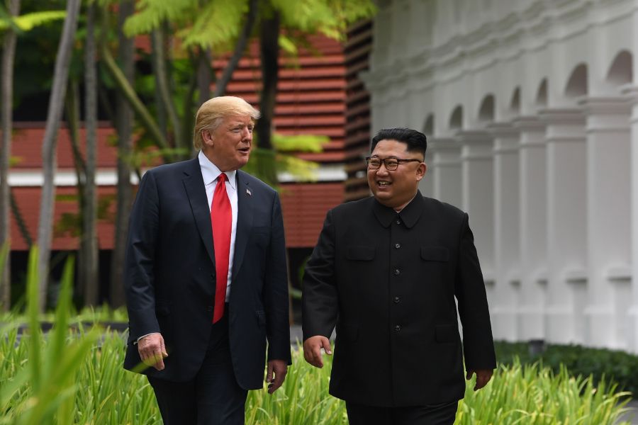 North Korea's leader Kim Jong Un (R) walks with US President Donald Trump (L) during a break in talks at their historic US-North Korea summit, at the Capella Hotel on Sentosa island in Singapore on June 12, 2018. (SAUL LOEB/AFP/Getty Images)