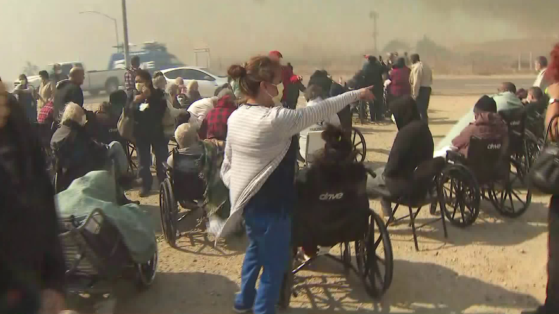 Residents of an evacuated skilled nursing facility, many in wheelchairs, could be seen awaiting transportation to hospitals in the Hill Fire in Jurupa Valley on Oct. 30, 2019. (Credit: KTLA)