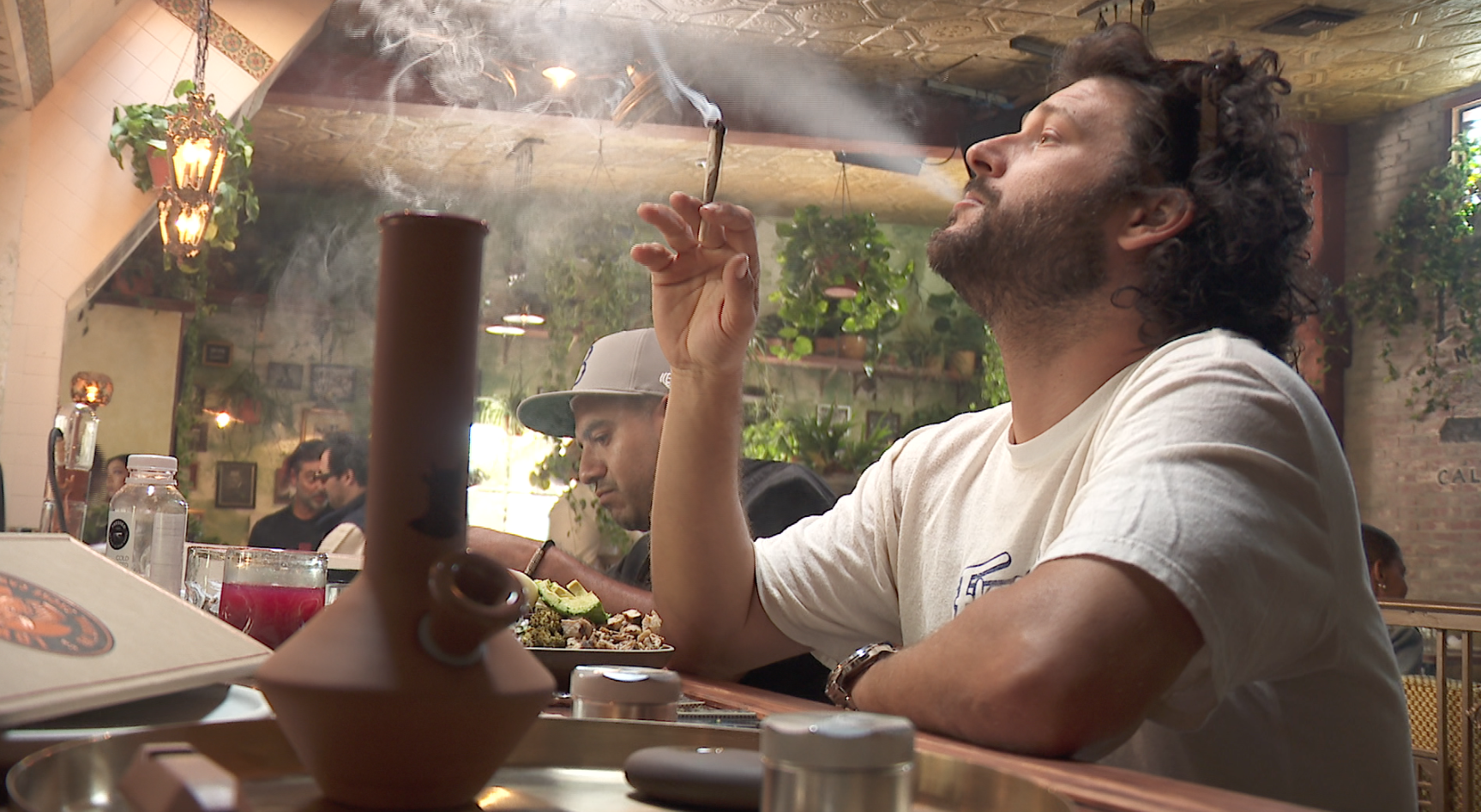 A man smokes at West Hollywood's Lowell Cafe on Oct. 1, 2091. (Credit: KTLA)