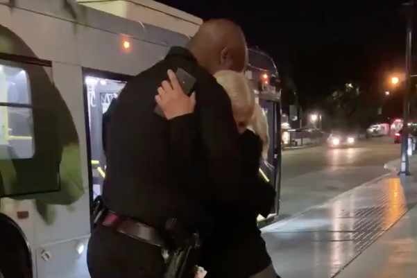 Emily Zamourka hugs Officer Frazier in a video tweeted by Los Angeles police on Oct. 3, 2019.