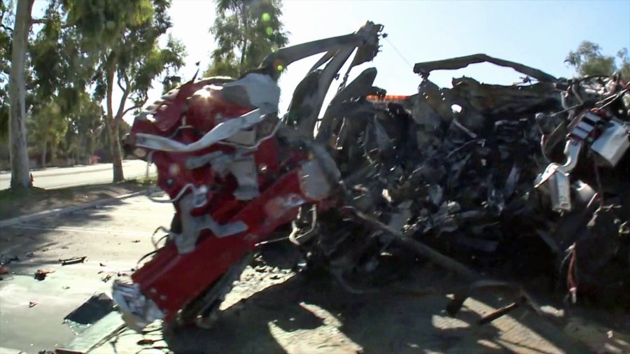 The wreckage of a car that crashed into a tree in Irvine, leave three people dead and fourth injured, is shown on Nov. 22, 2019. (Credit: KTLA)